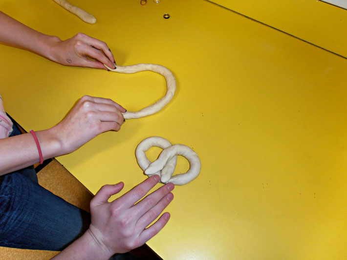 Since the dough was rolled out thinly we started to make the pretzel shape. We made about ten pretzels.